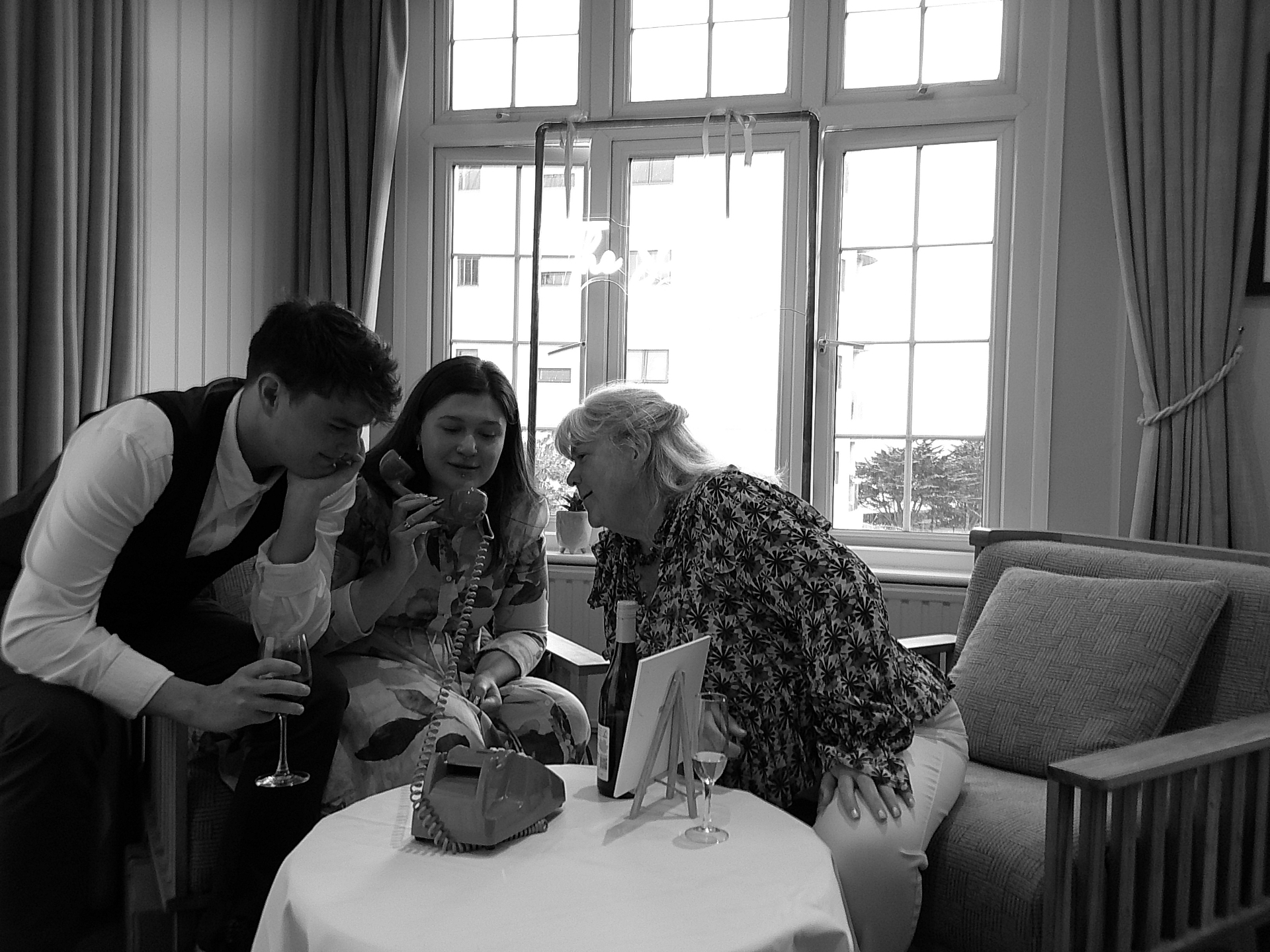 Wedding guests gathered around the RingBox phone recording a message
