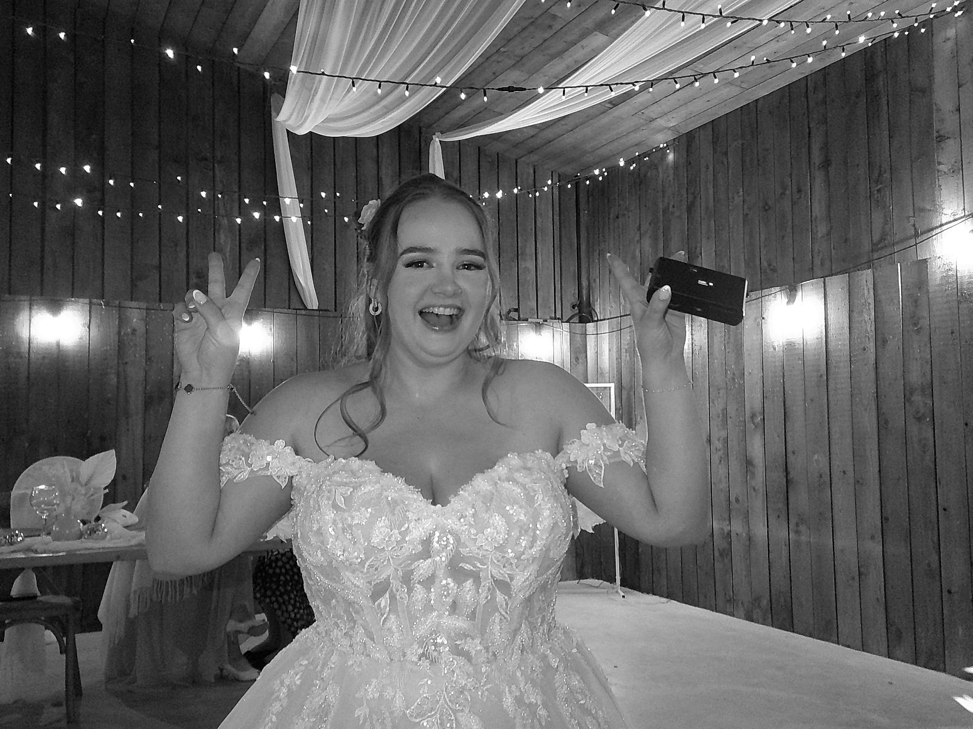 Bride holding a SnapBox camera and celebrating, shot on SnapBox